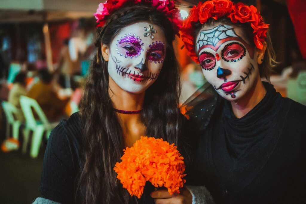 2 women with faces painted for dia del muertos 