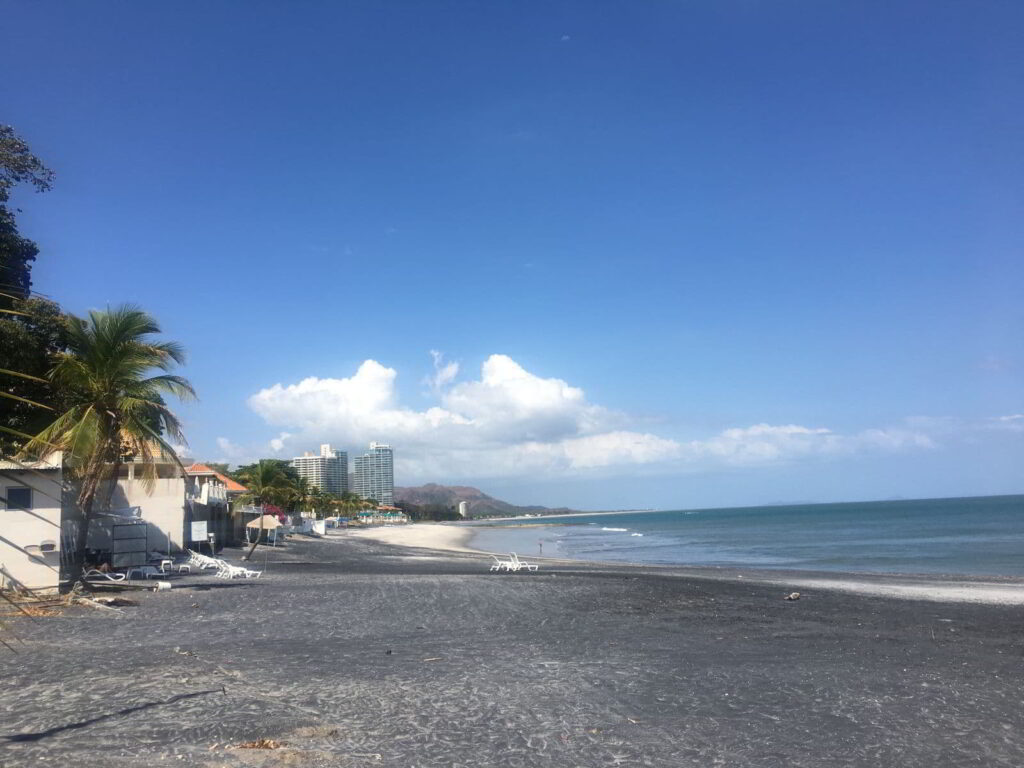 Black sand beach of Coronado on a sunny day, looking down towards Punta Chame