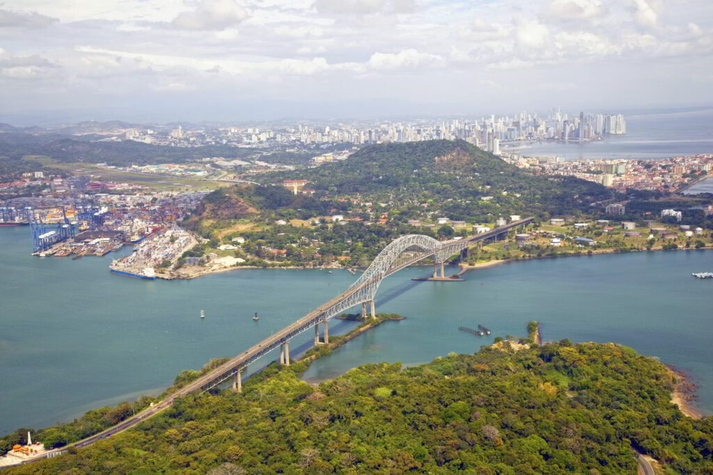 Aerial shot of the bridge over Panama Canal with Panama City in the background