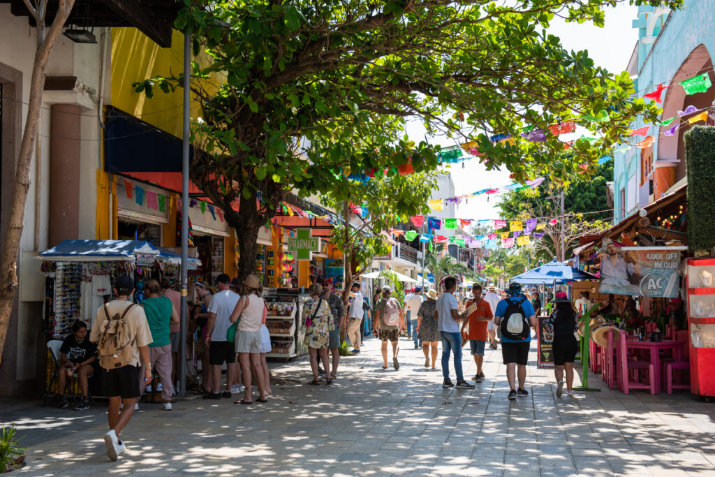 Tourists on 5th Ave in Playa del Carmen enjoy a walk in the sun