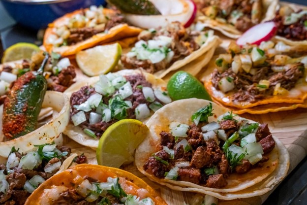 Image Source: iStock. Delicious freshly made tacos on a tray.