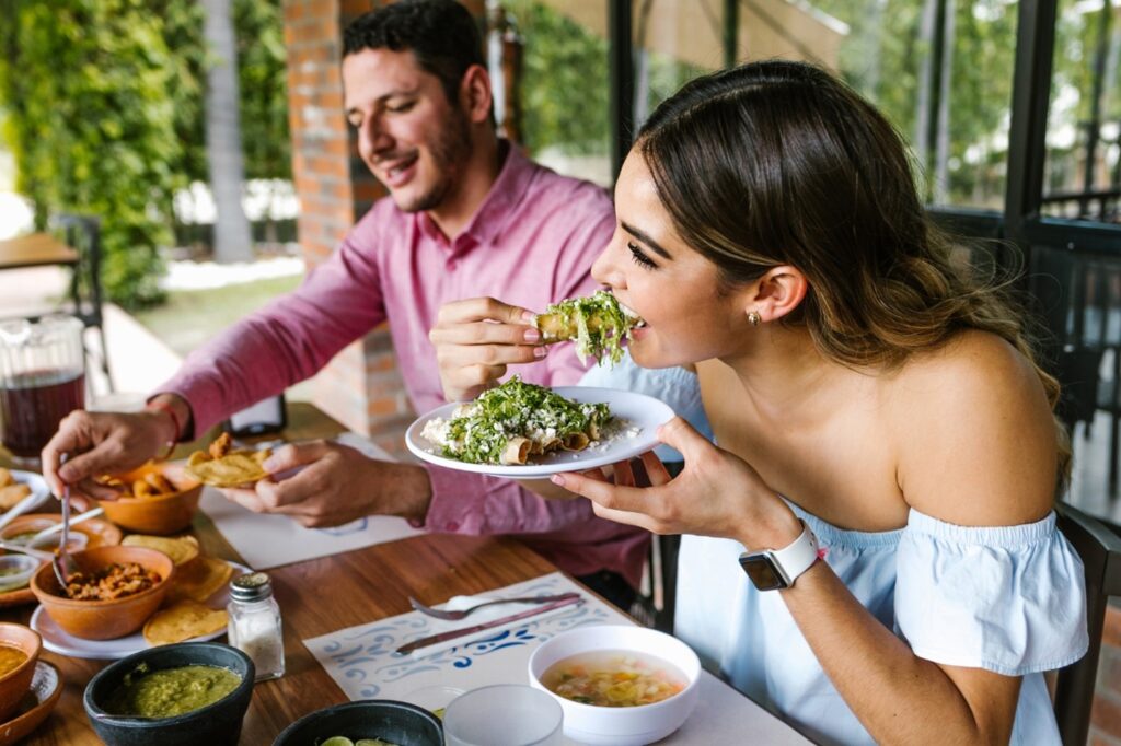 A couple enjoying Mexican food at a restaurant.