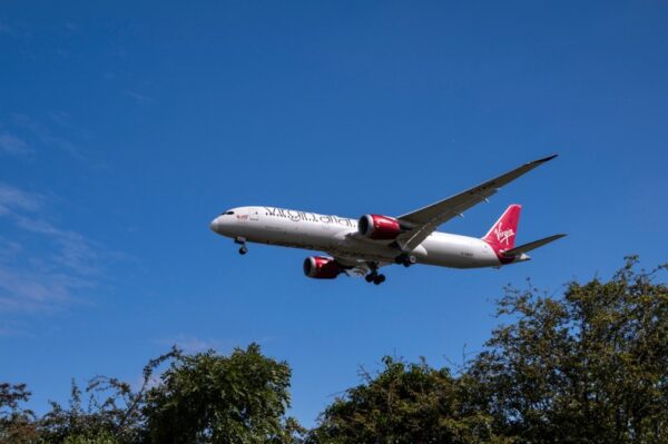 Virgin airlines airplane flying through the sky